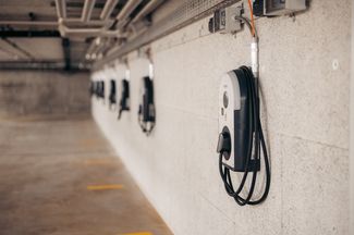 Mehrere Ladestationen für Elektroautos in der Garage eines Mehrfamilienhauses.